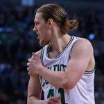 Kelly Olynyk (right) grabs his right shoulder after a collision with Clippers center DeAndre Jordan (left) in the first half of Wednesday night?s game. 