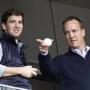 FILE - In this May 4, 2014, file photo, Denver Broncos quarterback Peyton Manning, right, points out something in the stadium to his brother, New York Giants quarterback Eli Manning, from New York Yankees' Derek Jeter's suite during a baseball game between the Yankees and the Tampa Bay Rays at Yankee Stadium in New York. Peyton Manning had a little fun with little brother Eli's sad face at the Super Bowl during an appearance on NBC's 