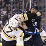WINNIPEG, MB - FEBRUARY 11: Patrice Bergeron #37 of the Boston Bruins and Blake Wheeler #26 of the Winnipeg Jets fight in second period action in an NHL game at the MTS Centre on February 11, 2016 in Winnipeg, Manitoba, Canada. (Photo by Marianne Helm/Getty Images)