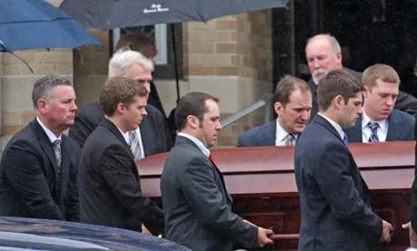 Mourners carried a casket during the funeral for Caitlin Clavette. 
