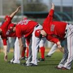 Boston Red Sox pitcher Junichi Tazawa, right, of Japan, warms up during a spring training baseball workout in Fort Myers, Fla., Saturday, Feb. 20, 2016. (AP Photo/Patrick Semansky)