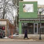 A new mixed-use development sat next to a store on South Florissant Road in Ferguson, Mo., last month. Ferguson city leaders are trying reach a settlement with the US Department of Justice to overhaul the city?s police and court system.