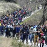 Hundreds of migrants walked from a camp near the Greek village of Idomeni Monday. 