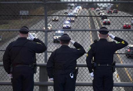 Three Weston police officers saluted as the motorcade escorting Massachusetts State Trooper Thomas Clardy's body passed by on I-90 to the morgue in Boston. 
