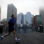 Boston, MA - 3/17/2016 - A man jogs along the Harborwalk in Fort Point channel as fog obscures the skyline in Boston, MA March 17, 2016. Jessica Rinaldi/Globe Staff Topic: Reporter: 
