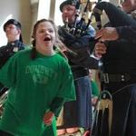 Boston, MA., 03/17/16, Jessica Doherty, 21, who attends the Kennedy Day School at Franciscans Children's, dances to the bagpipers and drummers of the Boston Police Gaelic Column of Pipes and Drums. They made a St. Patrick's Day visit to Franciscan Children's. 