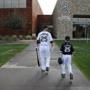 Former Chicago White Sox player Adam LaRoche and his son Drake walk to the clubhouse before a baseball spring training workout in Phoenix. 