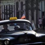 A taxi sported an American flag as it drove through the streets of Havana on Saturday. President Obama is scheduled to arrive in the country Sunday.