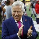 New England Patriots Chairman and CEO, Robert Kraft talks with others on the field as the team warms up before an NFL football game against the Dallas Cowboys, Sunday, Oct. 11, 2015, in Arlington, Texas. (AP Photo/Roger Steinman)