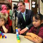 Dayami Calderon (left), 5, reacted as Mayor Marty Walsh posed for a photo with her and classmate Angiely Avelone, 4, at the Patrick J. Kennedy School in 2014.
