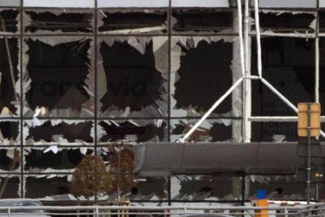 The blown out windows of Zaventem airport are seen after a deadly attack in Brussels, Belgium, Tuesday, March 22, 2016. Authorities in Europe have tightened security at airports, on subways, at the borders and on city streets after deadly attacks Tuesday on the Brussels airport and its subway system. (AP Photo/Peter Dejong)
