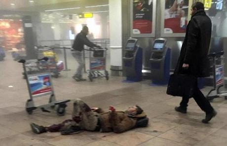 An injured man lies on the floor in Brussels Airport.
