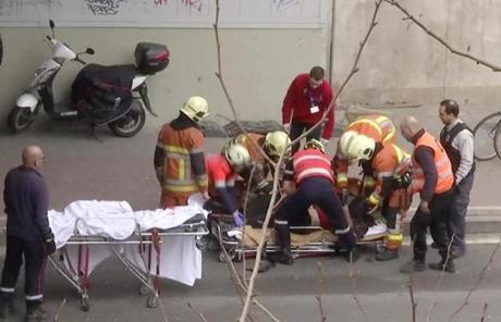 In an image made from video, emergency rescue workers stretcher an unidentified person at the site of an explosion.via AP)
