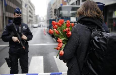 A woman arrived at the scene of a subway station bombing in Brussels bearing flowers.
