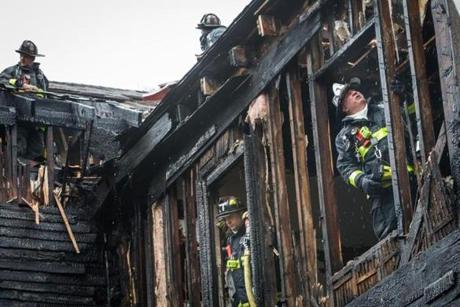 Firefighters worked to extinguish the remains of a fire that broke out at 42 Winthrop Street in Roxbury. 
