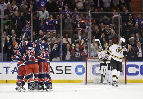 Boston Bruins goalie Tuukka Rask (40) and teammate Zdeno Chara (33) watch as the New York Rangers celebrate a goal by Derek Stepan during the first period of an NHL hockey game Wednesday, March 23, 2016, in New York. (AP Photo/Frank Franklin II)

