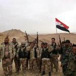 Syrian government soldiers held the national flag and posed during an operation in Palmyra on Saturday. 