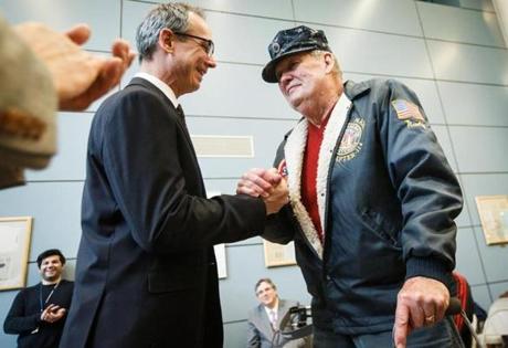 Bradley Mayes (left), director of the VA Regional Benefits Office, shook hands with Marty Grady, a Navy veteran of the Vietnam War.

