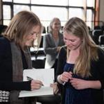 Gloria Steinem signs a book for a student at Northfield Mount Hermon.