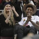 FILE - In this Jan. 14, 2015, file photo, Los Angeles Lakers' Nick Young, right, and Australian recording artist Iggy Azalea attend an NCAA college basketball game between UCLA and Southern California in Los Angeles. Lakers coach Byron Scott is 
