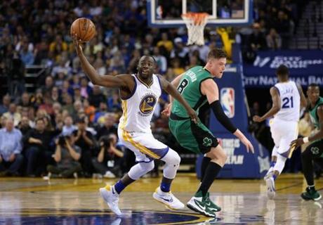 Jonas Jerebko of the Boston Celtics tried to steal the ball from Draymond Green of the Golden State Warriors at Oracle Arena on Friday in Oakland, Calif.
