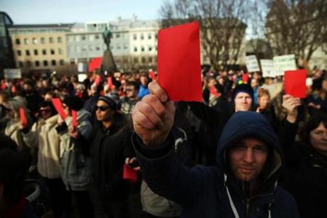 REYKJAVIK, ICELAND - APRIL 07: Hundreds of protesters gather in front of the Parliament building holding red cards for a fourth day on April 7, 2016 in Reykjavik, Iceland. Icelandic Prime Minister Sigmundur David Gunnlaugsson has stepped down after news broke last Sunday that he had hid his assets in an offshore shell-company whose existence was revealed by the Panama Papers. Numerous leaders around the world as well as wealthy individuals have been caught-up in the developing scandal. The island nation of just 320,000 people had only recently recovered from the global banking collapse in 2008. (Photo by Spencer Platt/Getty Images)
