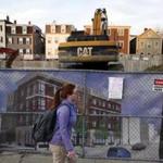 South Boston, MA - 3/9/2016 - A pedestrian walks past new construction in progress on West Broadway along the St. Patrick's Day Parade route in South Boston, MA March 9, 2016. Jessica Rinaldi/Globe Staff Topic: 17parade Reporter: 