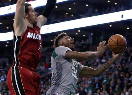Boston, MA - 04/13/16 - (1st quarter) Boston Celtics guard Marcus Smart (36) puts up a shot as he is defended by Miami Heat guard Goran Dragic (7) during the first quarter. The Boston Celtics take on the Miami Heat at TD Garden in the last home game of the regular season. - (Barry Chin/Globe Staff), Section: Sports, Reporter: Adam Himmelsbach, Topic: 14Celtics-Heat, LOID: 8.2.2608382143. 
