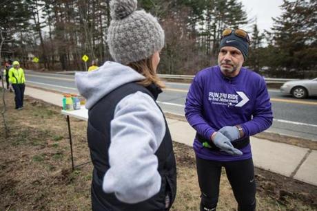 03/26/2016 NATICK Philip Posa (cq), (right) a runner with the Alzheimer Association's Boston Marathon team, is greeted by his wife Michele Posa (cq) at a water station while running along West Central Street in Natick during the team's charity run. (Aram Boghosian for The Boston Globe) 
