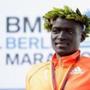 BERLIN, GERMANY - SEPTEMBER 28: First place winner and new world record holder Dennis Kimetto of Kenya poses on the podium after the 41th BMW Berlin Marathon on September 28, 2014 in Berlin, Germany. (Photo by Boris Streubel/Bongarts/Getty Images)