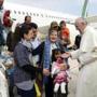 Pope Francis welcomes a group of Syrian refugees after landing at Ciampino airport in Rome following a visit at the Moria refugee camp in the Greek island of Lesbos, April 16, 2016. REUTERS/ Filippo Monteforte/Pool TPX IMAGES OF THE DAY