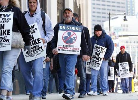 Verizon workers walked a picket line outside the company?s downtown Boston building on Thursday.
