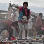 TOPSHOT - Ecuadorean Veronica Paladines, removes rubble in search for her husband at Tarqui neigbourhood in Manta, Ecuador on April 17, 2016 a day after a powerful quake hit the country. The toll from the big earthquake in Ecuador rose on Sunday to 246 dead and 2,527 people injured, the country's vice president said. / AFP PHOTO / Luis ACOSTALUIS ACOSTA/AFP/Getty Images