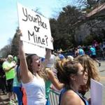 Spectators cheered for runners making their way along Commonwealth Avenue near Heartbreak Hill during the Boston Marathon.