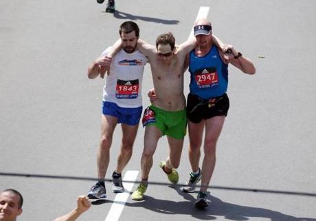 Jim Driscoll (left) and Mitch Kies (right) helped Ari Ofsevit (center) across the finish line.
