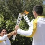 Former Brazilian volleyball player Giovane Gavio, left, receives the Olympic flame by Greek gymnast Eleftherios Petrounias, right, after the ceremonial lighting of the Olympic flame in Ancient Olympia, Greece, Thursday, April 21, 2016. The flame will be transported by torch relay to the Brazilian city of Rio de Janeiro, which will host the 2016 Olympic Games. (AP Photo/Petros Giannakouris)