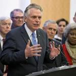 Virginia Gov. Terry McAuliffe is joined by members of the House and Senate as he announces a compromise on a set of gun bills at the Capitol in Richmond, Va., Friday, Jan. 29, 2016. (AP Photo/Steve Helber)