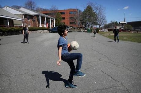 Abdul Wahab Al Rubaye and family members played soccer outside their two motel rooms in Saugus.
