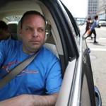 Uber driver Dean Johnson waited for a customer outside South Station on Friday. 