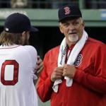 Boston Red Sox pitching coach Carl Willis chats with starting pitcher Wade Miley (20) before a baseball game against the Texas Rangers at Fenway Park in Boston, Tuesday May 19, 2015. (AP Photo/Elise Amendola)