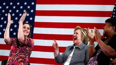 Erica Smegielski (left) applauded Hillary Clinton as she led a discussion on gun violence prevention with survivors of Sandy Hook victims in Hartford. 
