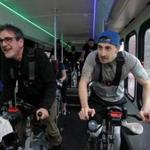 Reporters David Filipov (left) and Steve Annear work out on the BikeBus. 