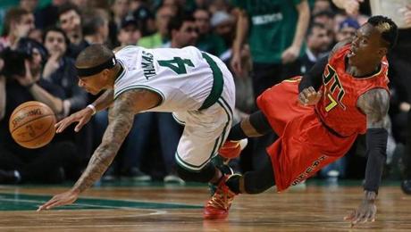 04/28/16: Boston, MA: The Celtics Isaiah Thomas (left) and Dennis Schroder (right) battle in the fourth quarter, hitting the floor after they collided. The Boston Celtics hosted the Atlanta Hawks in Game Six of an NBA Eastern Conference Quarter Final Playoff basketball game at the TD Garden. (Globe Staff Photo/Jim Davis) section:sports topic:Celtics-Hawks
