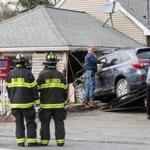 Firefighters and tow truck operators worked the scene after an SUV crashed into A Brighter Rainbow day care on Boston Road in Billerica.