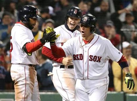 Christian Vazquez celebrated with Jackie Bradley Jr. (left) and Brock Holt after belting a go-ahead two-run homer in the seventh inning.
