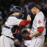 Boston Red Sox catcher Christian Vazquez, left, encourages starting pitcher Clay Buchholz during the fourth inning of a baseball game against the Chicago White Sox Wednesday, May 4, 2016, in Chicago. (AP Photo/Charles Rex Arbogast)