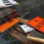 Signs were placed in a pile at a Green Line extension construction site in Gilman Square in Somerville. On Monday, state transportation officials will receive a report on how to scale back the project dramatically.