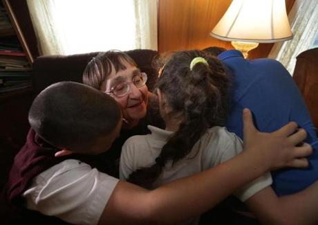 Mary Charette got a group hug from some of the kids in her house in Fall River.
