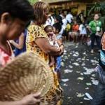 A woman carried her baby Monday while waiting to vote in Manila.