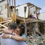 Shona Jupe, a resident of the apartment destroyed by the fertilizer plant explosion, hugs her friend as they met while she was visiting the site in West, Texas, on Friday, May 10, 2013. Jupe was at the front door when the West Fertilizer Co. explosion happened. Texas law enforcement officials on Friday launched a criminal investigation into the massive fertilizer plant explosion that killed 14 people last month, after weeks of largely treating the blast as an industrial accident. (AP Photo/The Dallas Morning News, Kye R. Lee) MANDATORY CREDIT; MAGS OUT; TV OUT; INTERNET OUT; AP MEMBERS ONLY